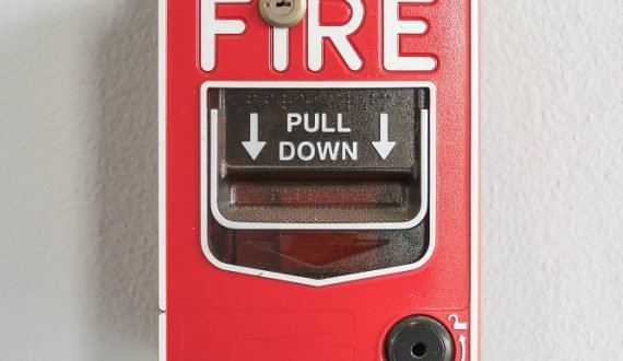 Fire alarm switch on white wall