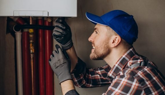 Service man adjusting house heating system